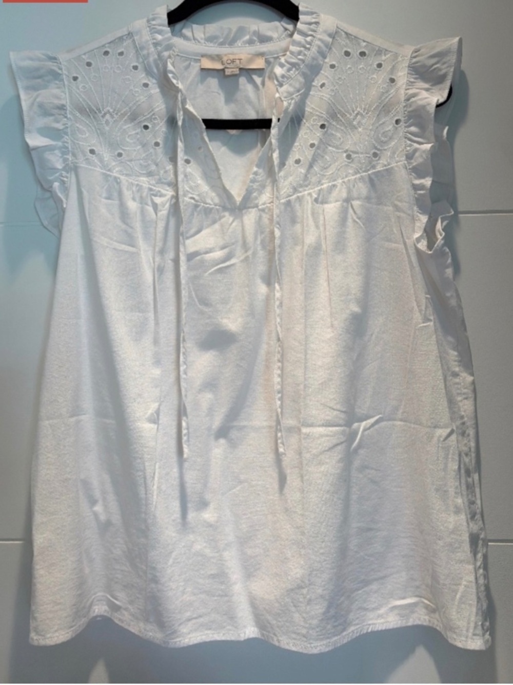 Sleeveless white cotton blouse